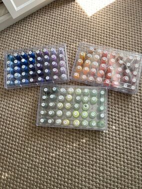 Set of 3 Acrylic Trays with embroidery sewing machine spools .